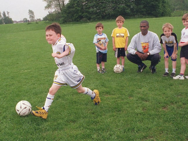 Young Luke Smith on a football course at Holt Park Leisure Centre in June 1999. He is under the watchful eye of his coach Rod Christopher and players , from left , William Caress, Gregory Eacock, Adrian Eacock and Thomas Darbyshire.