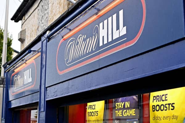 Signage on the front of a William Hill betting shop. It plans to close around 200 betting shops across the UK (Photo: Paul ELLIS / AFP)
