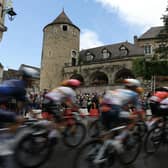 The riders in this year's Tour de France cycle through the town of Buxy, in Burgundy, one of the sights you can see on Eurosport's coverage of the event (Picture: THOMAS SAMSON/AFP via Getty Images)
