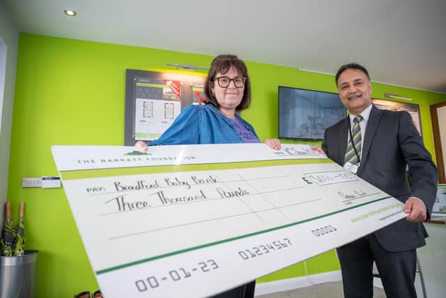 B&DWYW - SGB-37894 - Kinder from Barratt Homes presenting Vickie from Bradford Baby Bank with her cheque