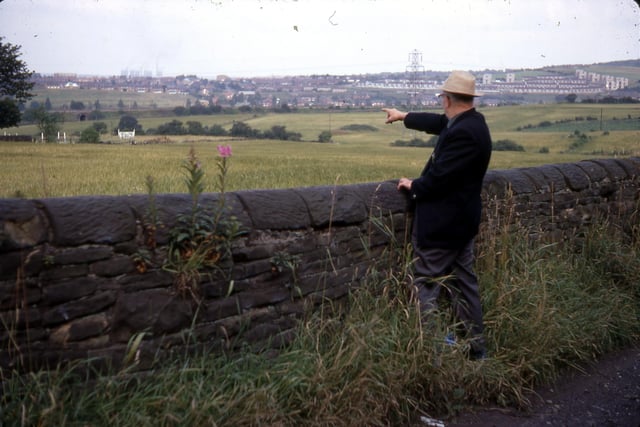 A view towards the railway line from a path beyond Back Green Methodist Church in July 1968. The area beyond the lone man, Bob Dennis, is where the Mary Pit was to be found. He is pointing towards Cardinal Estate on the Ring Road, Beeston. Mr. Dennis wrote a history of Churwell as well as poetry about local folk and customs.