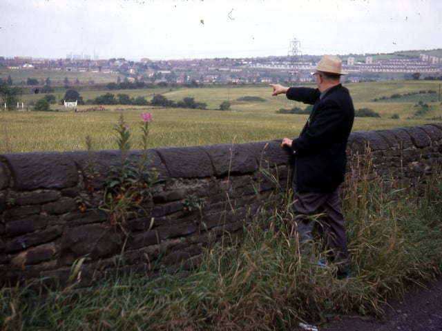 A view towards the railway line from a path beyond Back Green Methodist Church in July 1968. The area beyond the lone man, Bob Dennis, is where the Mary Pit was to be found. He is pointing towards Cardinal Estate on the Ring Road, Beeston. Mr. Dennis wrote a history of Churwell as well as poetry about local folk and customs.