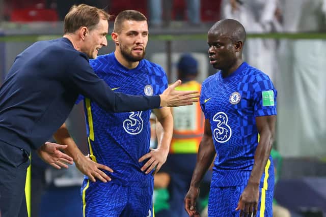 Chelsea's coach Thomas Tuchel (L) speaks with Chelsea's midfielder Mateo Kovacic (C) and midfielder N'Golo Kante during the 2021 FIFA Club World Cup final football match between Brazil's Palmeiras and England's Chelsea at Mohammed Bin Zayed stadium in Abu Dhabi, on February 12, 2022. (Photo by Giuseppe CACACE / AFP) (Photo by GIUSEPPE CACACE/AFP via Getty Images)