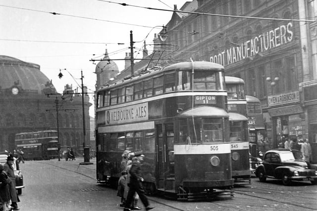 Looking from Duncan Street towards Corn Exchange showing Tram No 505 and on route 11 to Gipton and tram 545 travelling route 15 to Whingate in April 1955. Jewellers Owen and Robinson can be seen on right.