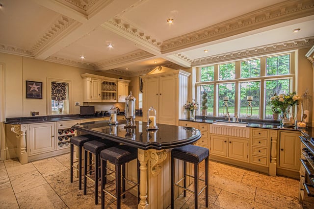 A central island with granite work surface is a main feature of the kitchen.