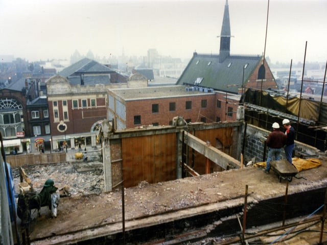 Demolition underway in readiness for construction of the Schofields Centre which opened in 1990. The view looks down onto the site and across to Lands Lane. The red brick and white building with the circular window housing shop premises in Lands Lane is located next to Angel Inn Yard and is called Scala House. It was formerly the premises of the 1,629 seater Scala Cinema which opened on 24th June 1922. Above the cinema there was the Scala Ballroom. Nearer to the camera is the rear of the red brick Church Institute at the corner of Lands Lane with Albion Place, addressed then as number 5 Albion Place.