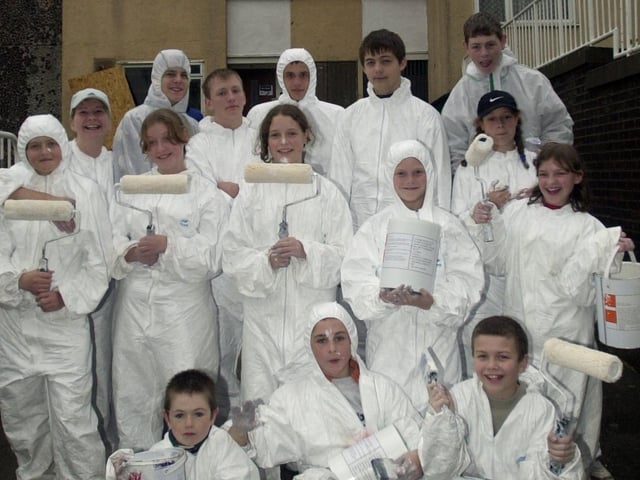 Flats on Park Wood Road were enjoying a lick of paint by children in the community in October 2002. Pictured is housing manager Cindy Costigan, second left, with some of the youngsters.