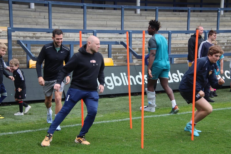 Fans try out their footwork at Rhinos' sponsors' training day. Justin Sangare, in the background, remains in a protective boot as he recovers from a season-ending foot injury.