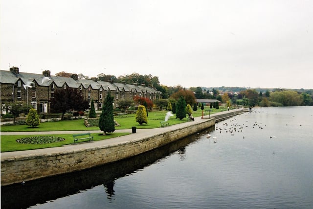 The River Wharfe showing Wharfemeadows Park and terraced houses on Bridge Avenue at the rear in October 2003. Before these houses were built (about 1899) the site was nicknamed 'Klondyke' after the gold rush in Alaska near the Yukon River in 1898. This was because prospective buyers could stake their claim to a plot of land previously owned by Doctor Williamson of Romagna House, Boroughgate. The houses here were built by contractor, Tom Maston.