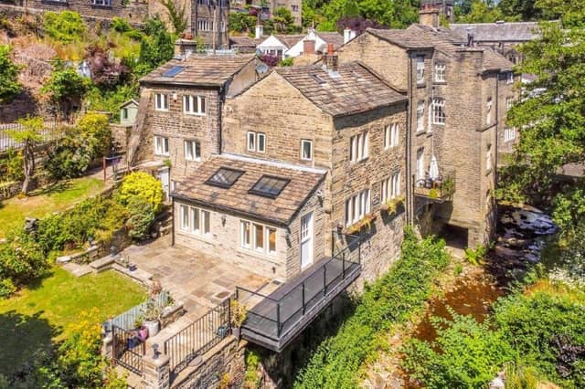 The property's acre or so of grounds include wooded areas and a stream.