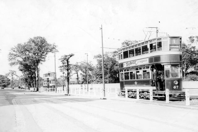 Two trams travelling along Otley Road in the direction of Lawnswood in July 1939. The view looks back towards the Shaw Lane area of Headingley. The tram in the background is number 205 with number 67 seen to the right. The destination of number 67 is listed as Lawnswood via Woodhouse Lane.
