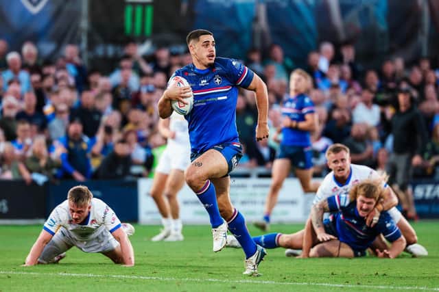 Caleb Hamlin-Uele dashes clear to score for Wakefield Trinity against Leeds Rhinos. Picture by Alex Whitehead/SWpix.com.