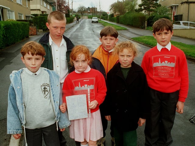 Children are pictured with a petition in April 1996 calling for the creation of a play area .