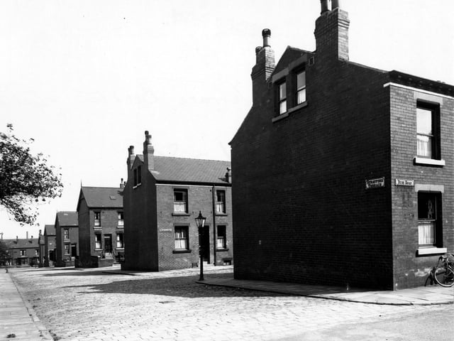 A view down Stratford Terrace in August 1949, showing the gable ends and junctions with Bude Road and Trentham Row. A gas streetlamp is central. The streets are cobbled.