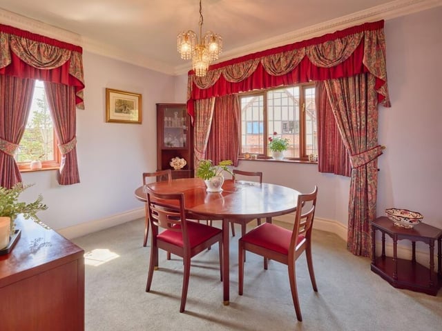 The dual-aspect dining room features an attractive bay window.