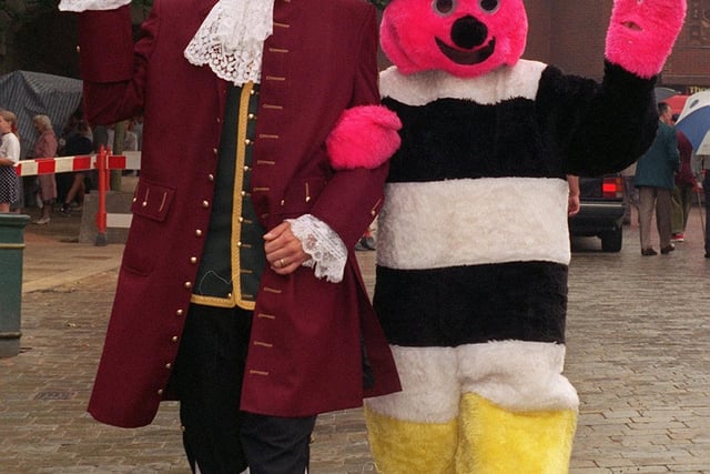Pontefract Town Cryer, David Walters, escorts Bertie Bassett on a stroll round Pontefract following the official opening of the Pontefract Liquorice Fayre in August 1997.