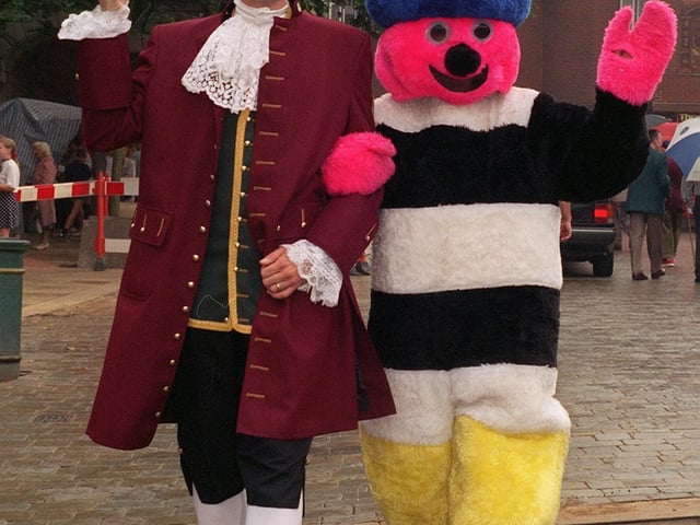 Pontefract Town Cryer, David Walters, escorts Bertie Bassett on a stroll round Pontefract following the official opening of the Pontefract Liquorice Fayre in August 1997.