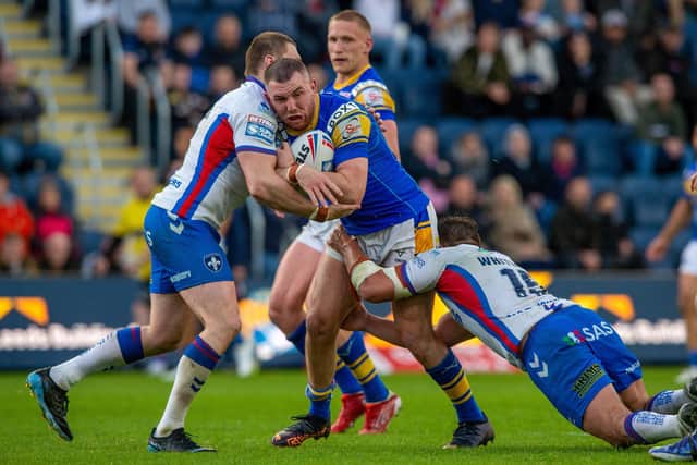 Cameron Smith is tackled by Jai Whitebread and Kelepi Tanginoa during Rhinos' home win over Wakefield Trinity in May.  Picture by Bruce Rollinson.