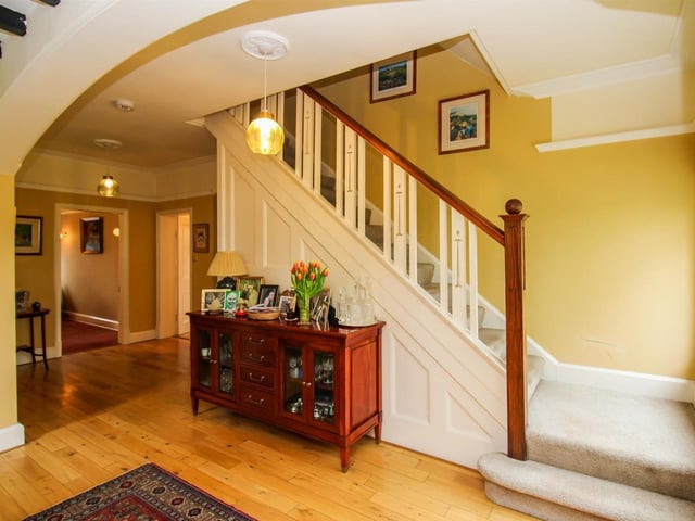 The home opens into a welcoming entrance vestibule which leads through to an inner hallway with a hidden reading nook.