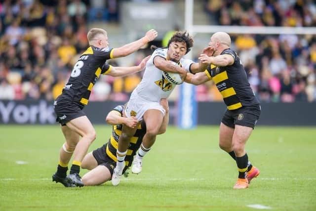 Castleford Tigers Phoenix Laulu-Togaga’e holds off York duo Will Roberts, left and Paul McShane. Picture by Tony Johnson.