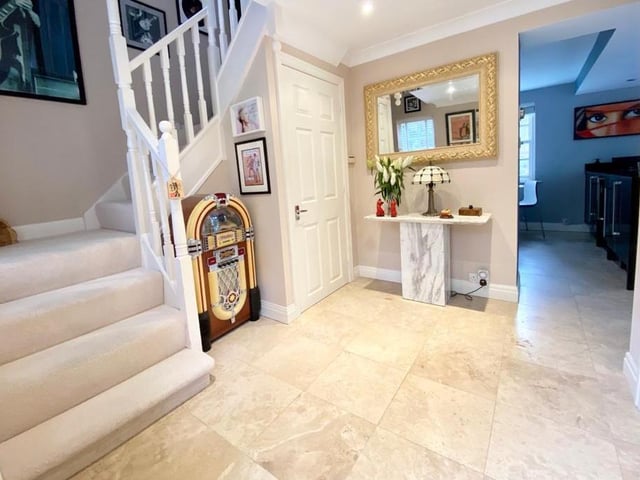 A spacious hallway has under floor heating.