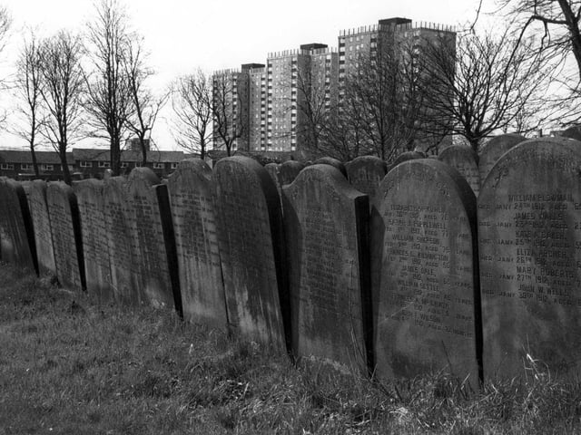 Beckett Street cemetery showing rows of inscription graves or 'guinea graves'. The graves on the right here date from 1912. In the background are the high-rise flats of Shakespeare Towers, Court and Grange.