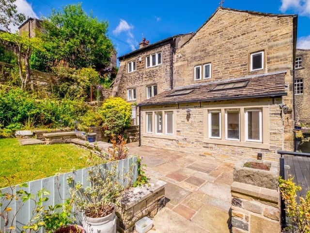 A patio area fronts the lawn in this part of the garden