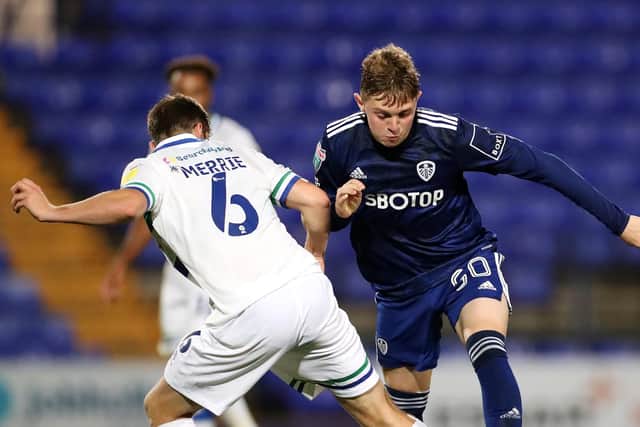BIRKENHEAD, ENGLAND - SEPTEMBER 14: Max Dean of Leeds United is challenged by Chris Merrie of Tranmere Rovers during the Papa John's Trophy match between Tranmere Rovers and Leeds United U21 at Prenton Park on September 14, 2021 in Birkenhead, England. (Photo by Lewis Storey/Getty Images)