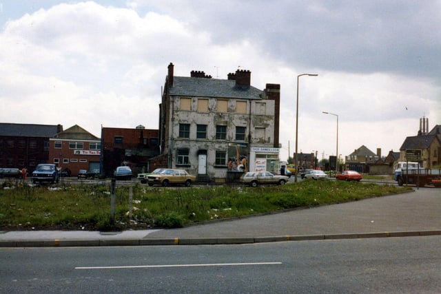 Forster Street, foreground, at the junction with Hunslet Road, seen right, in May 1979. The dilapidated building with boarded windows on the third floor is Thomas Dawes & Son and has a takeaway food shop on the corner.