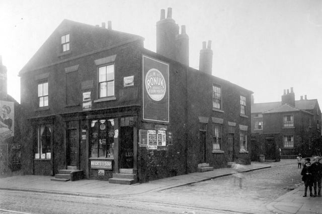 Children in the street, dustbins and outside toilets on Humane Street off Low Road in August 1929. To the left on Low Road is the premises of George Mackintosh, pawnbrokers assistant and George Henry Brown, shopkeeper.