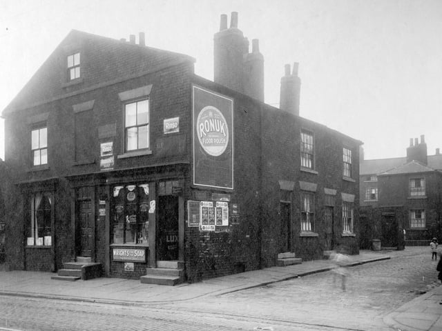 Children in the street, dustbins and outside toilets on Humane Street off Low Road in August 1929. To the left on Low Road is the premises of George Mackintosh, pawnbrokers assistant and George Henry Brown, shopkeeper.