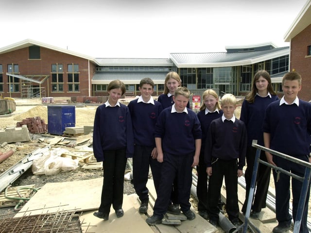 Brigshaw high School pupils, from left, Stephanie Hands, Lewis Todd, Emma James, Sean Bower, Megan Gladman, Daniel Hill, Katie Joynes and Alex Fletcher in front of the new school building, pictured on June 26, 2002.