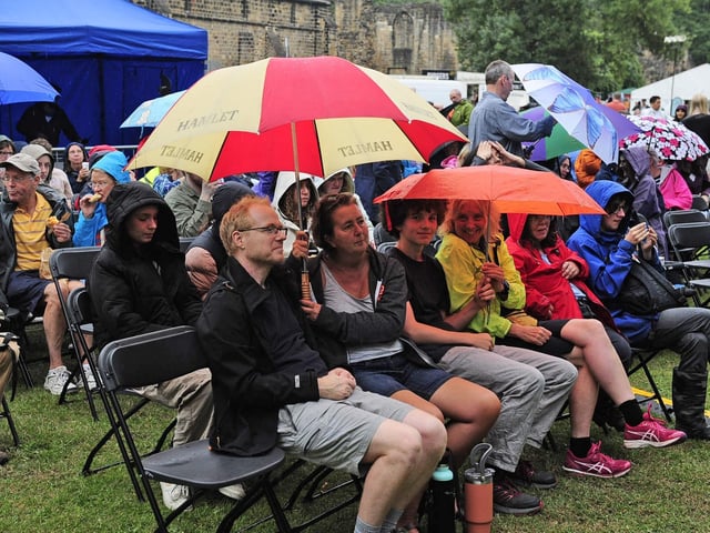 The audience braves the wet weather for the bands. (pic by Steve Riding)