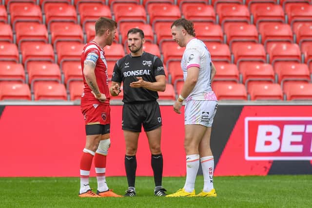 Leeds Rhinos captain Cameron Smith, right and Salford Red Devils' Marc Sneyd talk to referee Aaron Moore during a game in 2023. From next season, skippers will be able to challenge decisions made by the man in the middle. Picture by Olly Hassell/SWpix.com