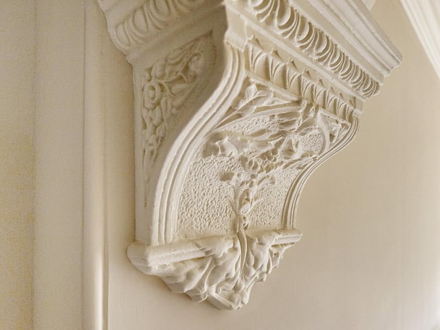 The property showcases decorative arched recesses, high ceilings, ornate cornices and coving, and leaded glass windows.