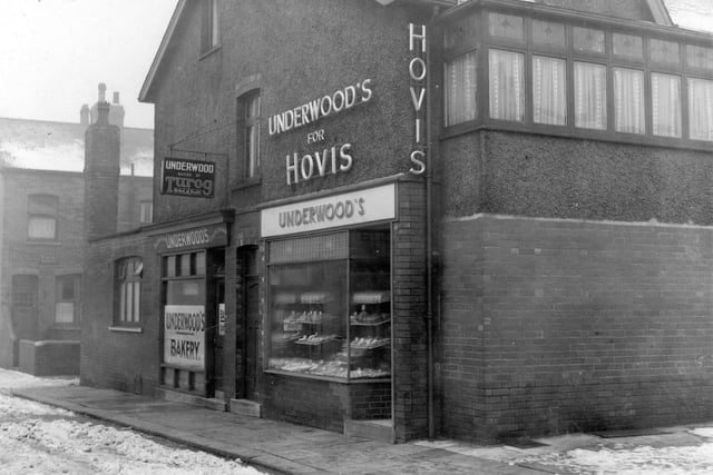 Underwood's Bakery on Theodore Street pictured in January 1939. There are advertising signs for Hovis and Turog bread. There are goods in the window. Part of the end of Back Barkly Terrace can be seen.