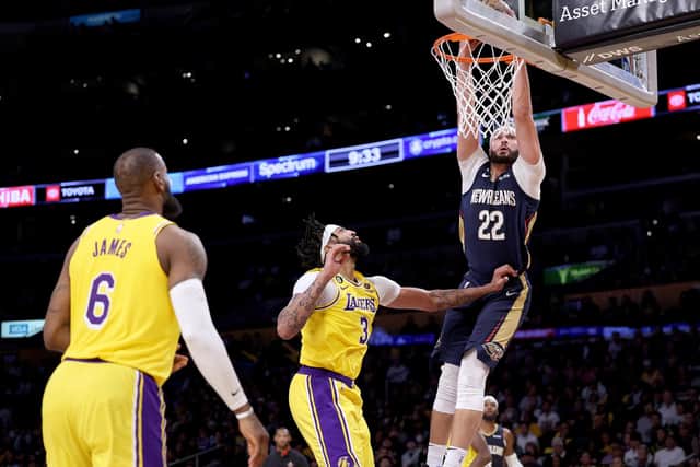 LEEDS INTEREST - Larry Nance Jr of the New Orleans Pelicans dunks in front of Anthony Davis and LeBron James of the Los Angeles Lakers. The 6ft 8ins Pelicans man has taken an interest in Leeds United. Pic: Getty
