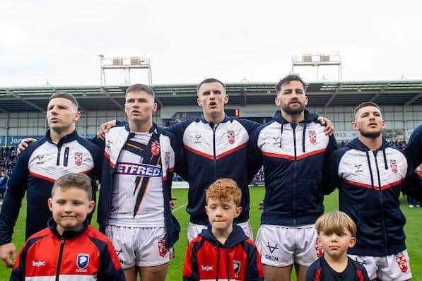 Rhinos' Ash Handley, middle, sings the national anthem, along with George Williams, Jack Welsby, Toby King, Danny Walker and the team mascots, ahead of his England Test debut. Picture by Allan McKenzie/SWpix.com.