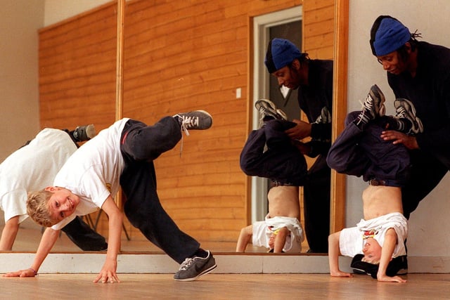 Steve Johnson a teacher and member of Union City Summer School is seen helping Ben Cerigo to breakdance while Daniel Cerigo, pictured left, goes through one of his routines.