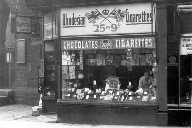 Fred Groves, tobacconist shop has various signs and advertisements in view. Pictured in September 1937.