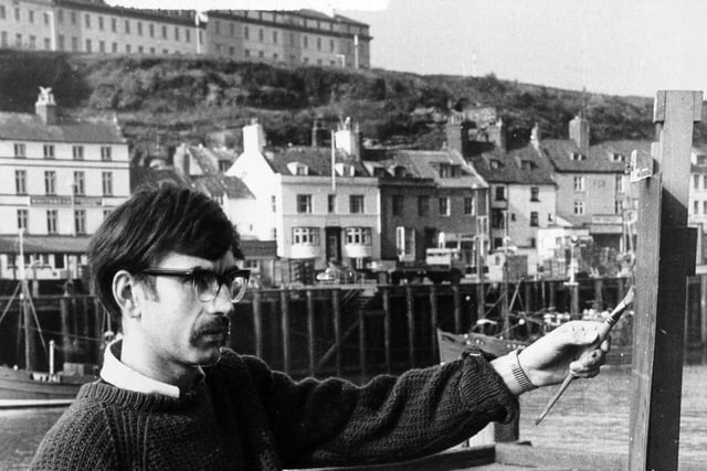 Artist John Freeman painting Whitby Harbour in March 1971.