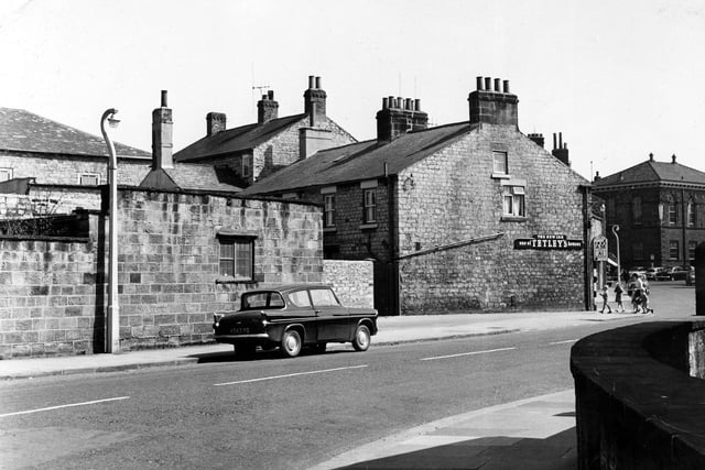 Westgate showing the New Inn, at the junction with Bank Street. In the background right the Town Hall in Market Place can be seen. A Ford Anglia is parked in Westgate. Pictured in July 1962.
