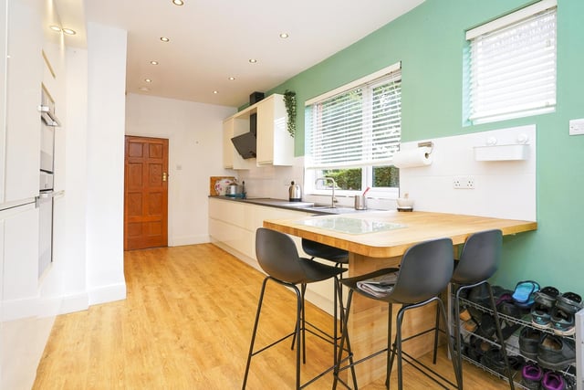 There is also a dining room with patio doors leading into the rear garden, and a high gloss kitchen with integrated appliances and a breakfast bar.