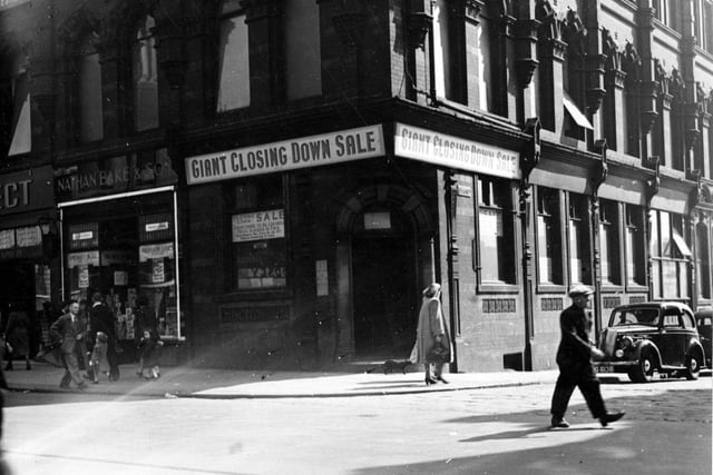 The corner of Vicar Lane and Sidney Street in May 1949.  The shop having a closing down sale, appears to be Nathan Bake and Son.