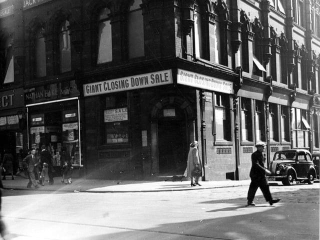 The corner of Vicar Lane and Sidney Street in May 1949.  The shop having a closing down sale, appears to be Nathan Bake and Son.