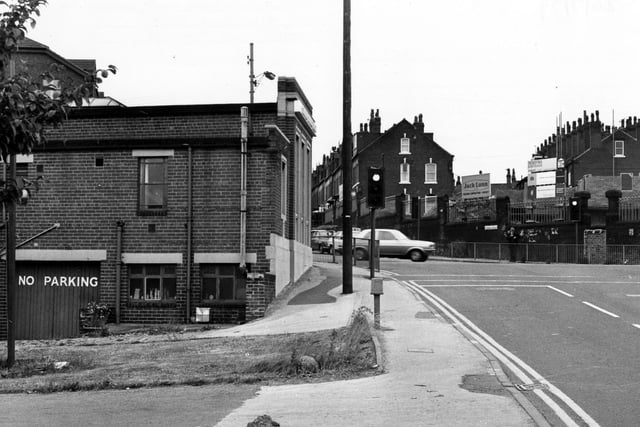 On the left of Willow Lane is the Trustee Saving Bank. On the right visible across Burley Road is a building site under the management of the Jack Lunn Building Contractors. The traffic lights and cars are visible at the junction. Pictured in July 1979.