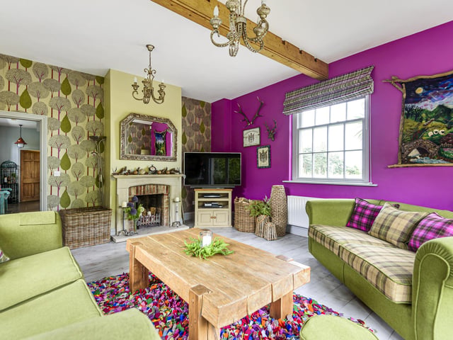 Ceiling beams and fireplaces are features of many rooms within the converted barn.
