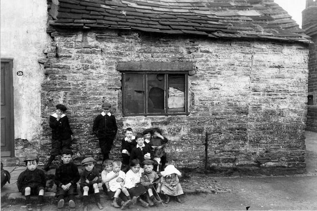 Children stand outside property adjoining no.14 Woodhouse Cliff in June 1913.