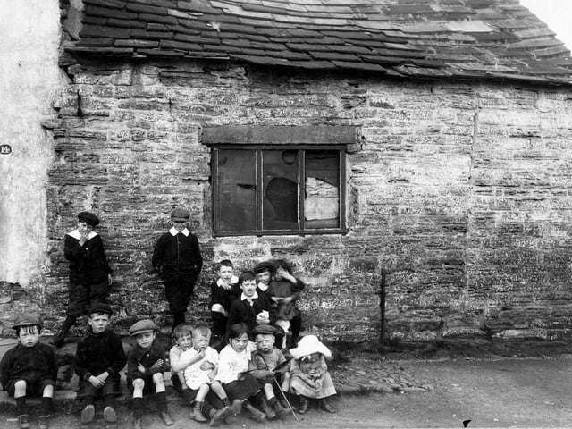 Children stand outside property adjoining no.14 Woodhouse Cliff in June 1913.