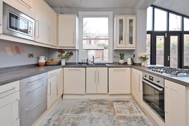 The kitchen has a good range of base and wall units in cream including a glazed display cabinet, and silver drawers, says the brochure. It also features wood effect work surfaces and a breakfast bar separating the living area from the kitchen with an integrated five ring gas hob and electric oven, dishwasher and washing machine.